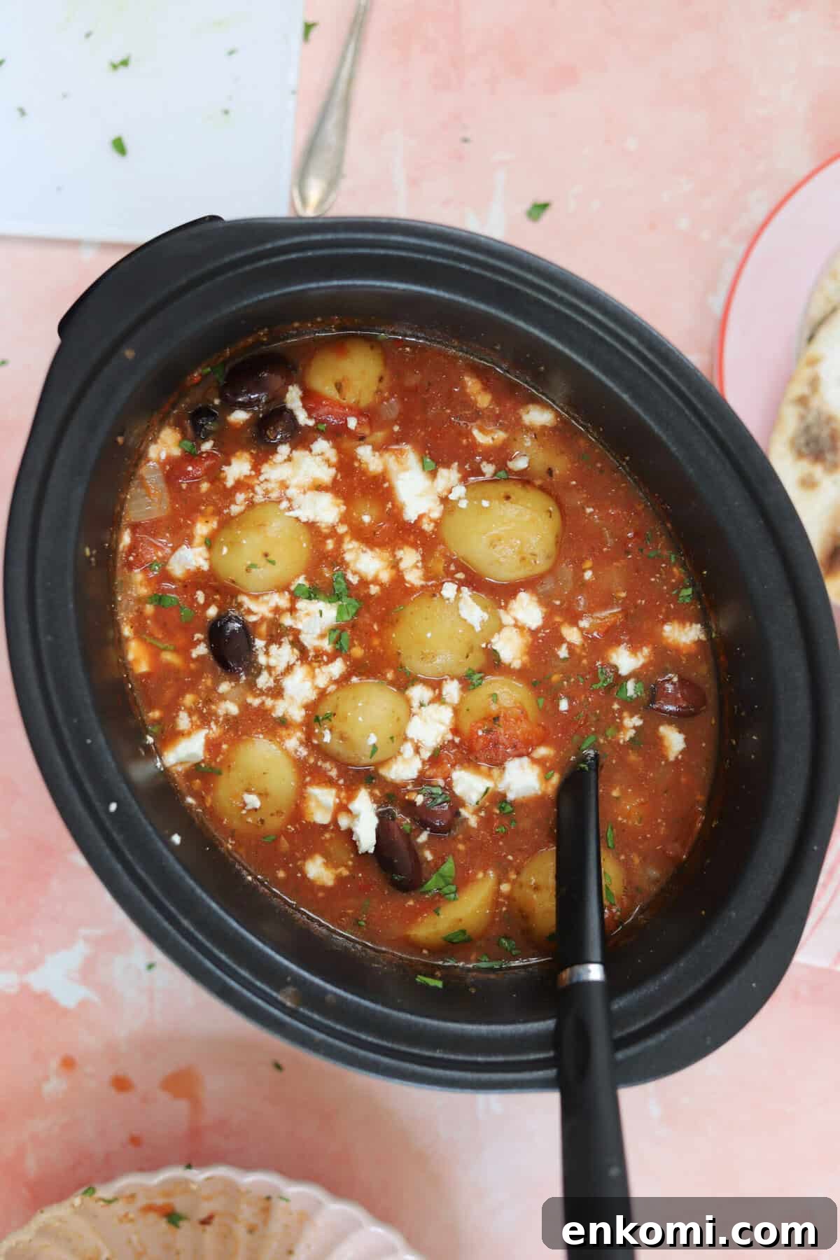 Slow Cooker Greek Potato Stew with Feta and Lemon 4 A slow cooker pan filled with Greek potato stew.