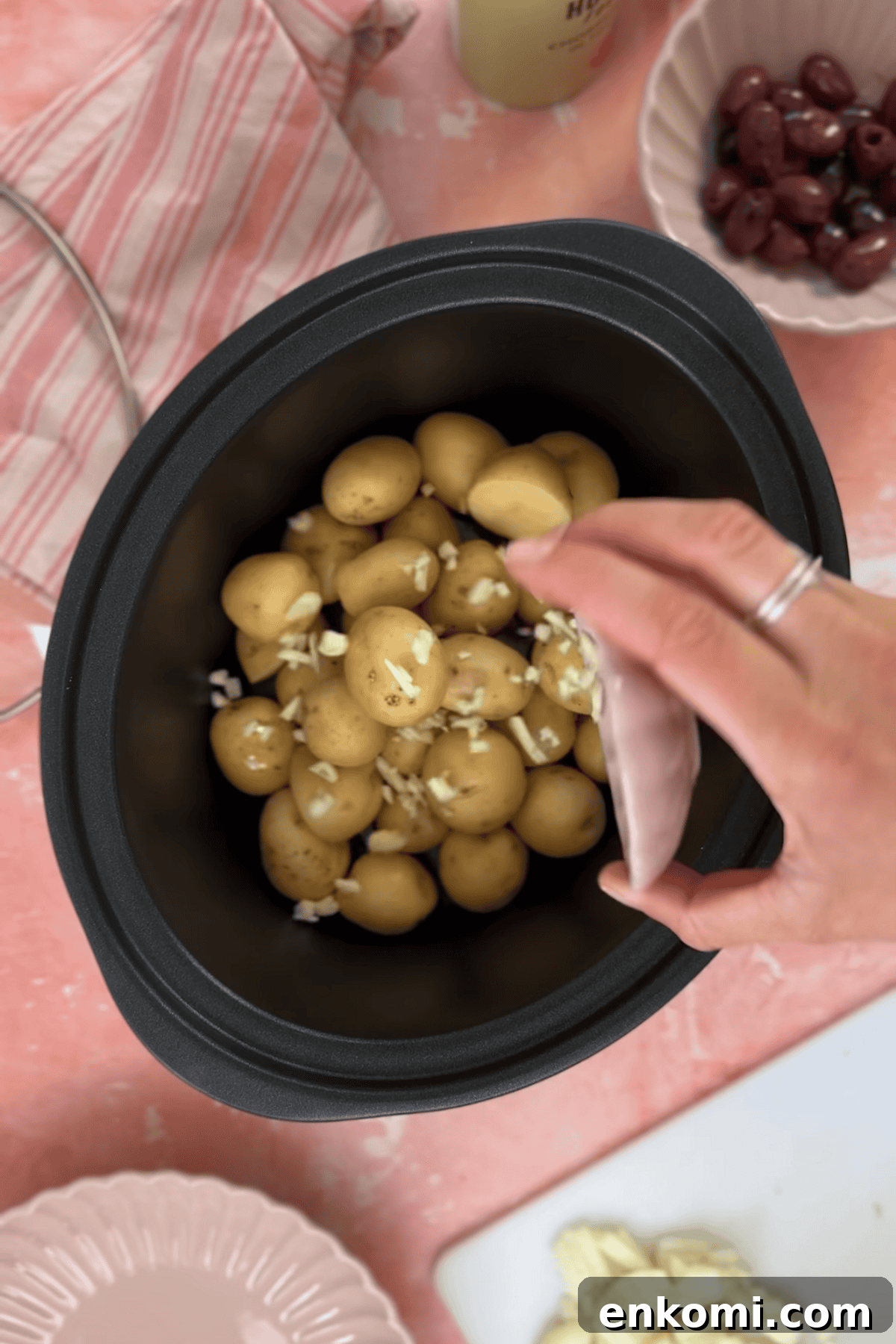 Slow Cooker Greek Potato Stew with Feta and Lemon 5 Adding the potatoes onions and garlic to a pan.