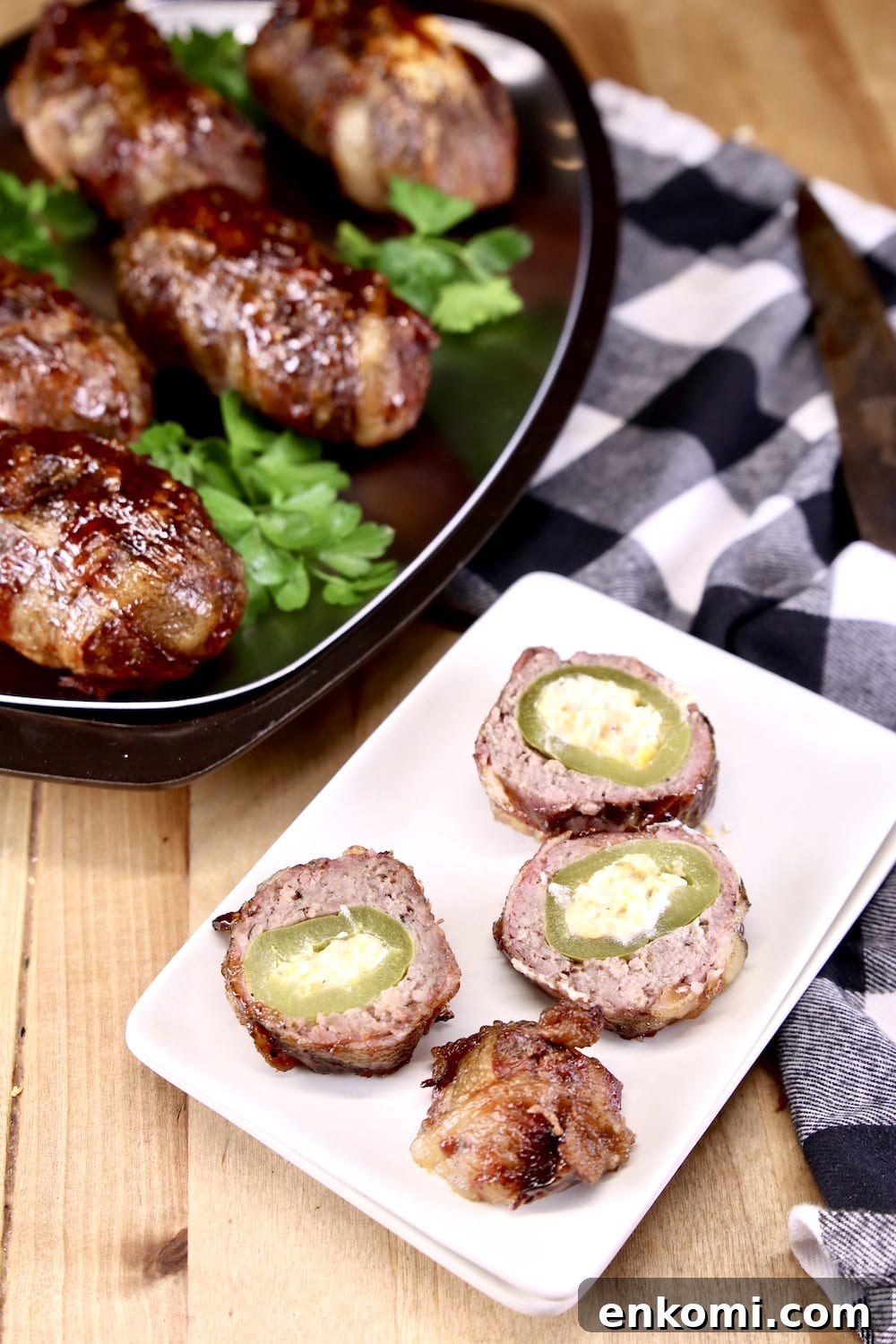 plate of armadillo egg - sausage wrapped jalapeno popper