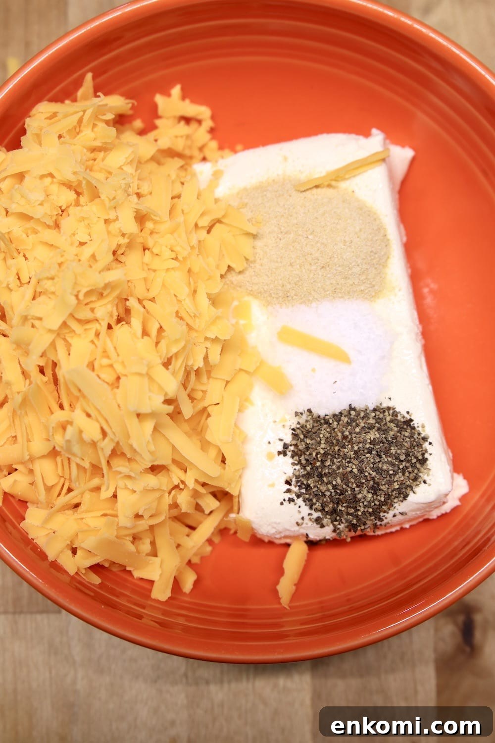 bowl with cheddar cheese, cream cheese, salt and pepper