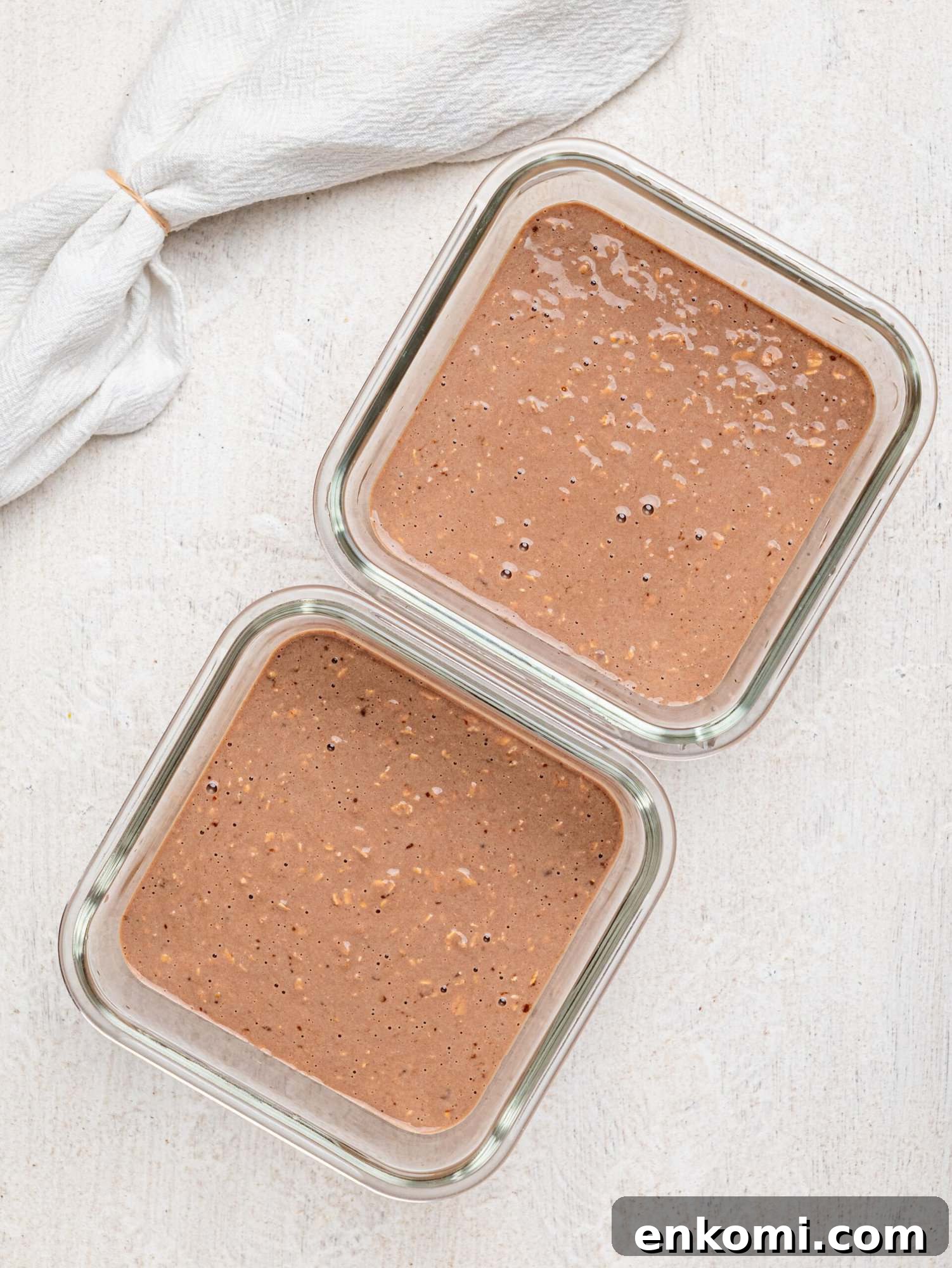 Creamy chocolate protein overnight oats in meal-prep containers.