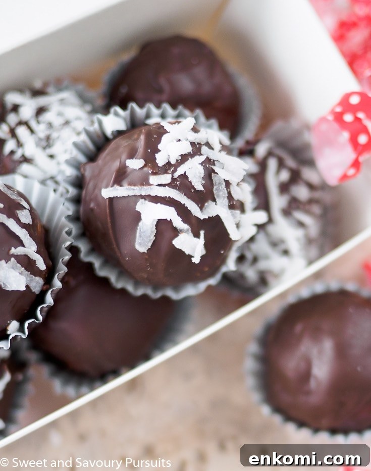 Top view of a box of chocolate coconut truffles.