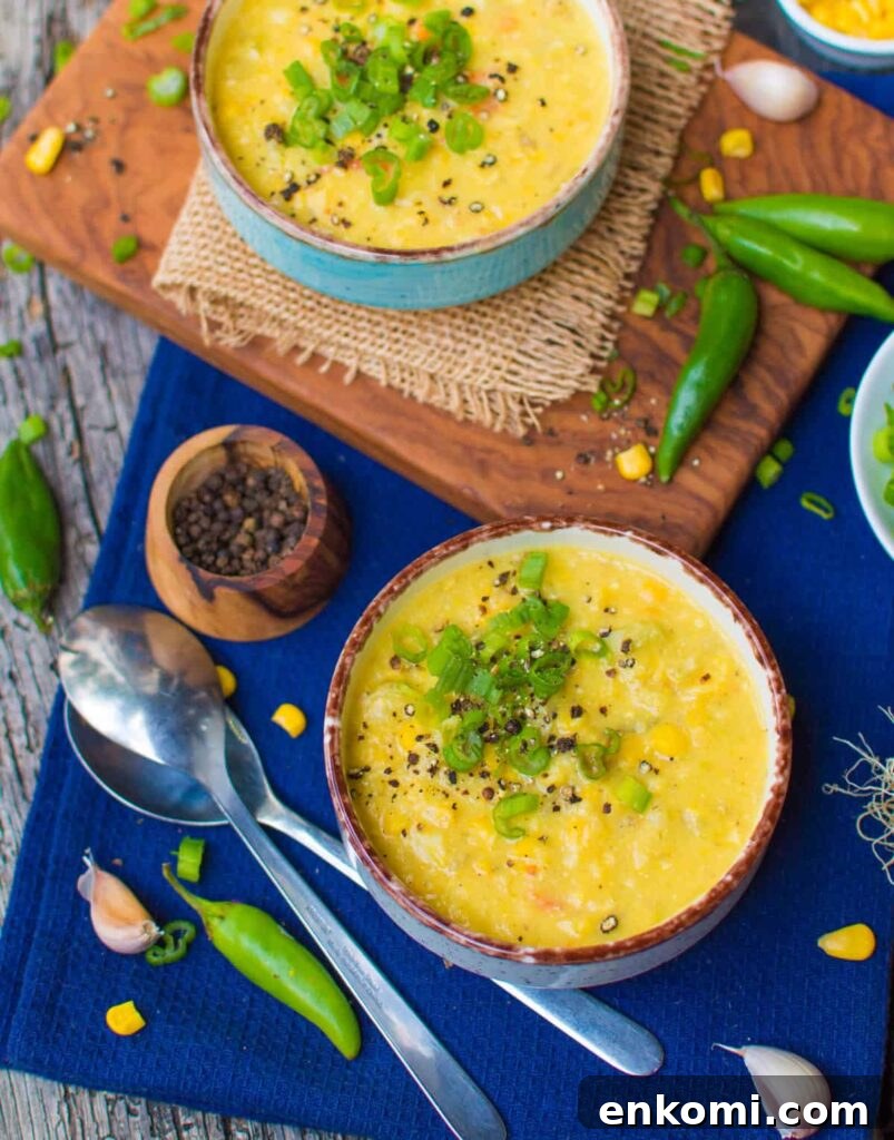 a bowl of corn chowder with green onions