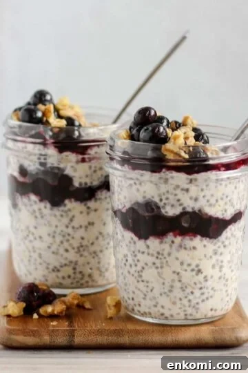 Two mason jars filled with overnight oats with chia seeds and blueberries