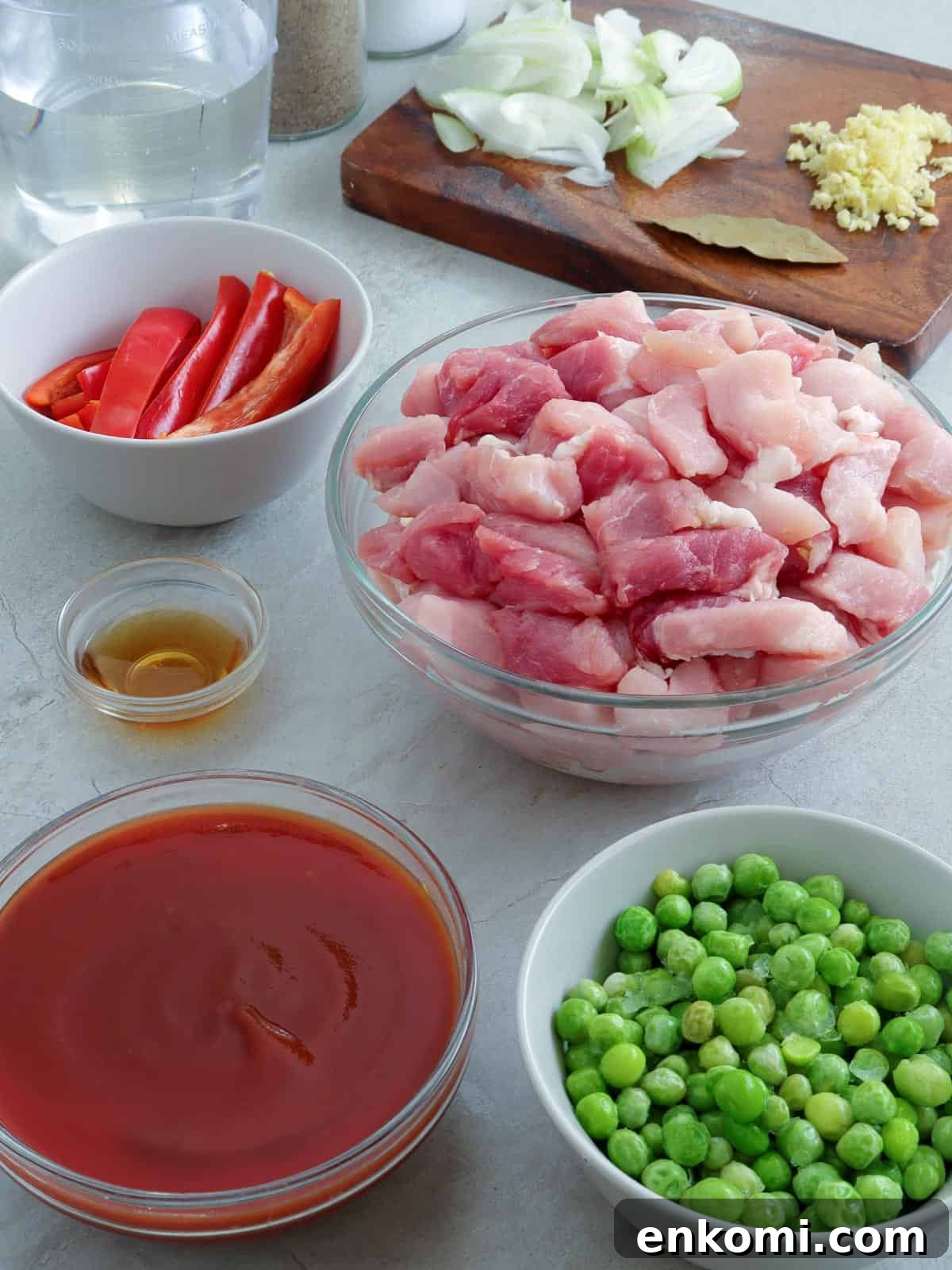 pork strips, green peas, bell pepper strips, tomato sauce, fish sauce, chopped onions, minced garlic, bay leaves