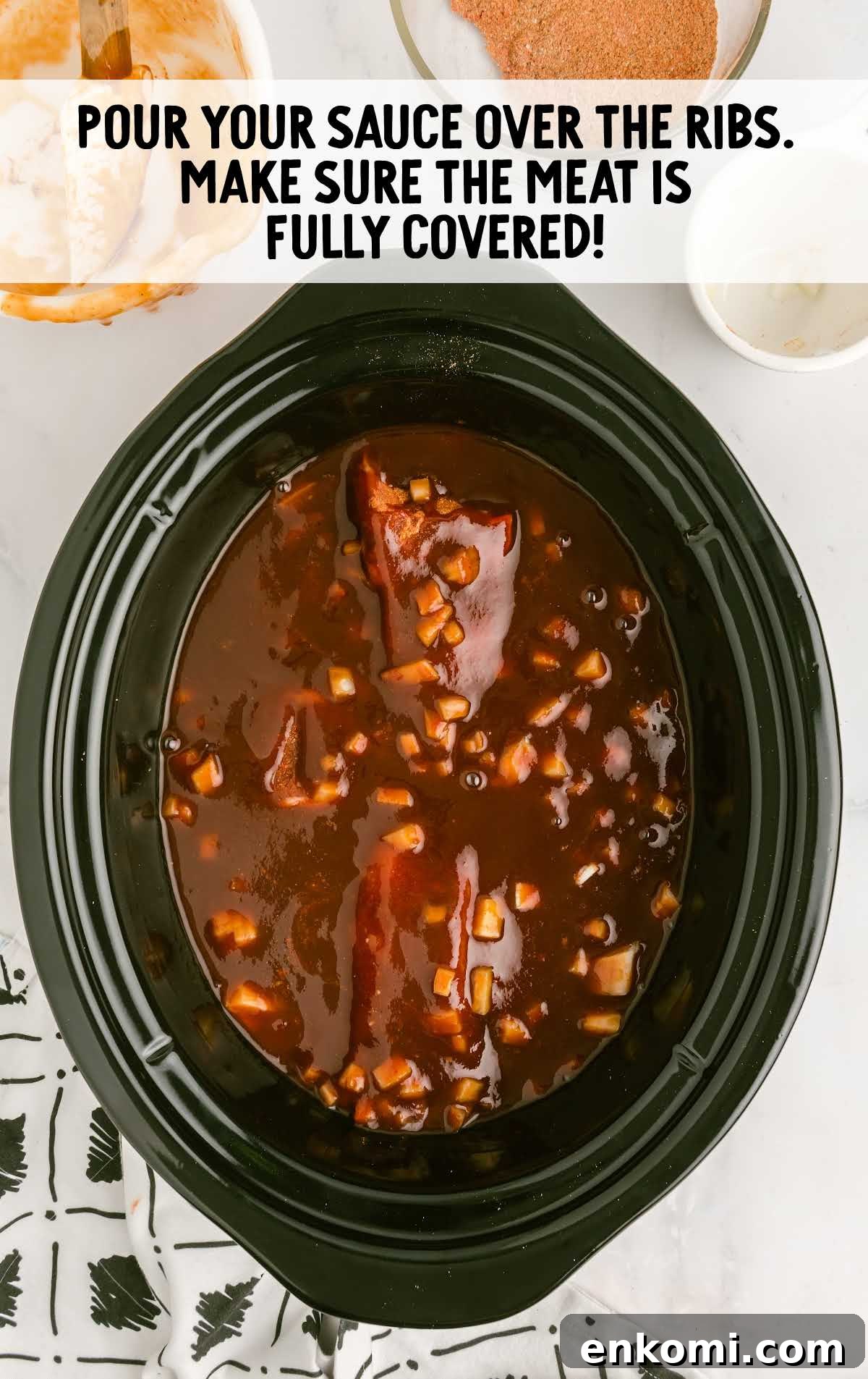 Slow Cooker Country-Style Ribs with Tangy BBQ Sauce 5 sauce poured over the ribs in a slow cooker
