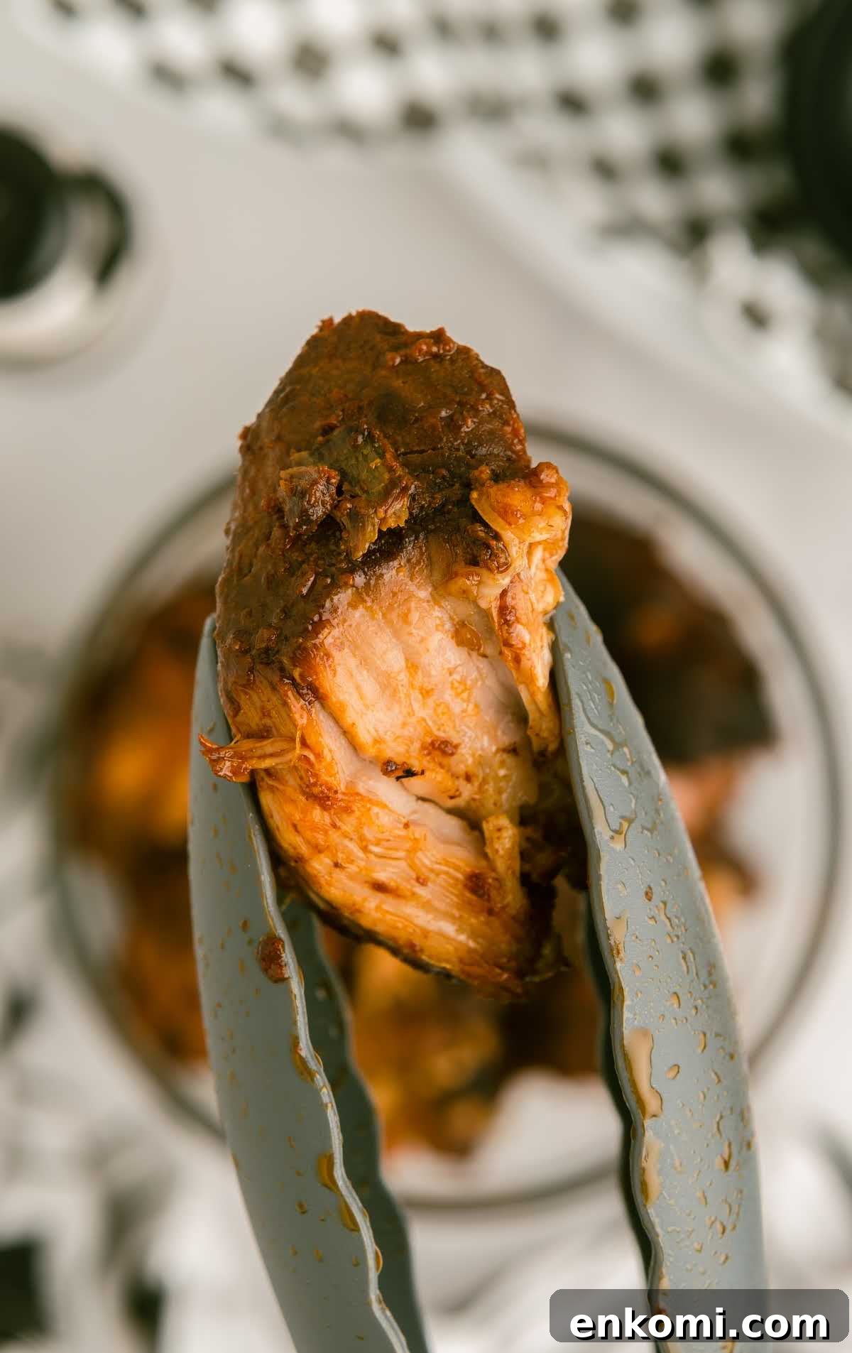Slow Cooker Country-Style Ribs with Tangy BBQ Sauce 7 close up shot of slow cooker country style pork ribs on tongs