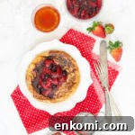 Bubula on white plate with compote and a cup of tea.
