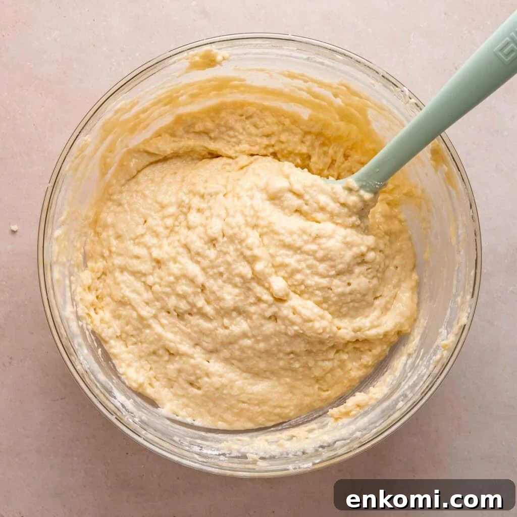 Coffee cake batter in a bowl with a spatula.