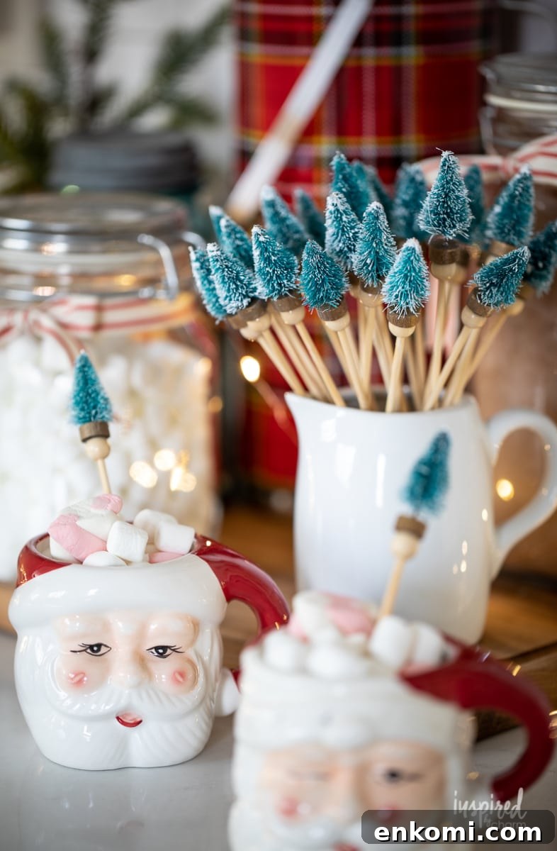 Bottle Brush Tree Drink Stirrers in a small pitcher and Santa mugs.