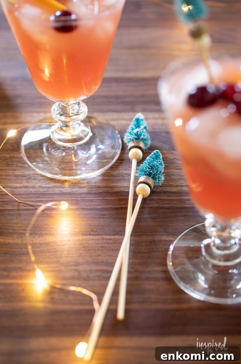 Bottle Brush Tree Drink Stirrers next to two cocktails.