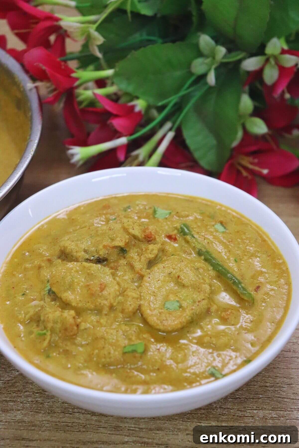 Authentic Goan Clam Curry Recipe 2 Goan clam curry (Tisryache Tonak) served in a bowl on a brown countertop.