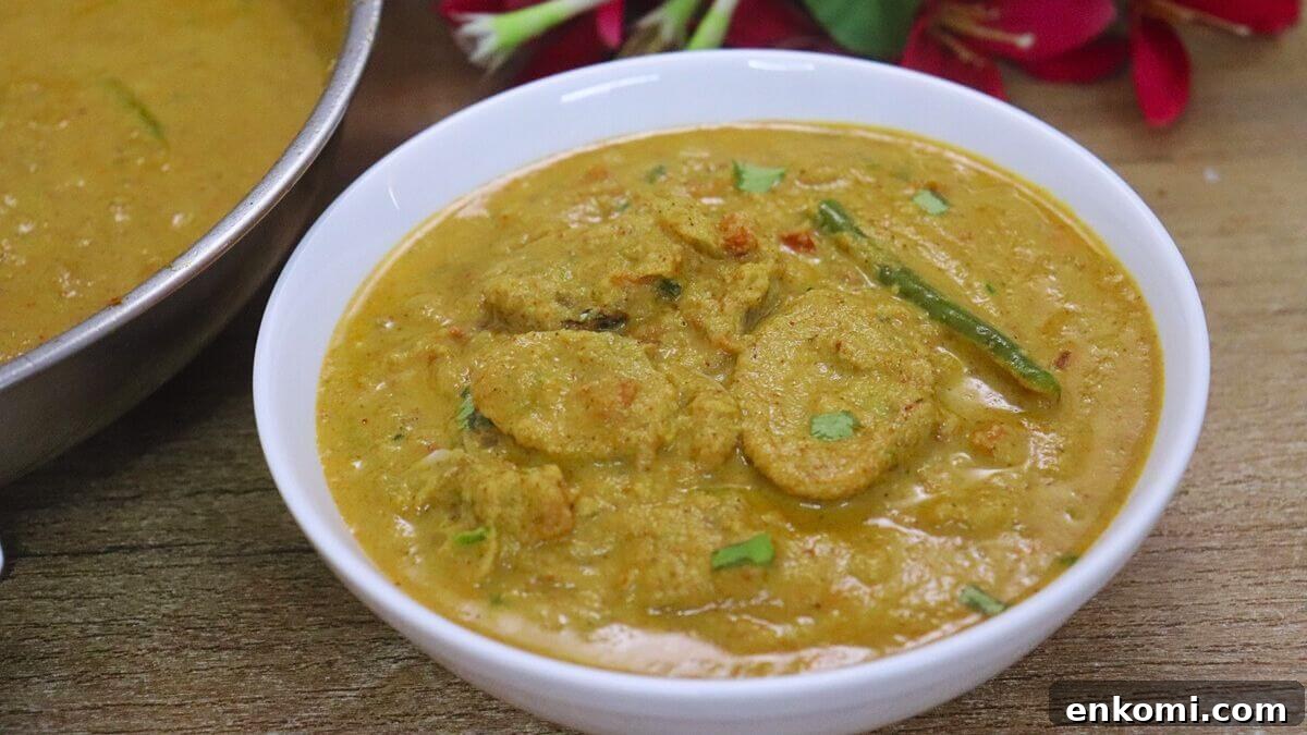 Authentic Goan Clam Curry Recipe 14 Traditional Goan clam curry made with coconut masala is served in a white color bowl.