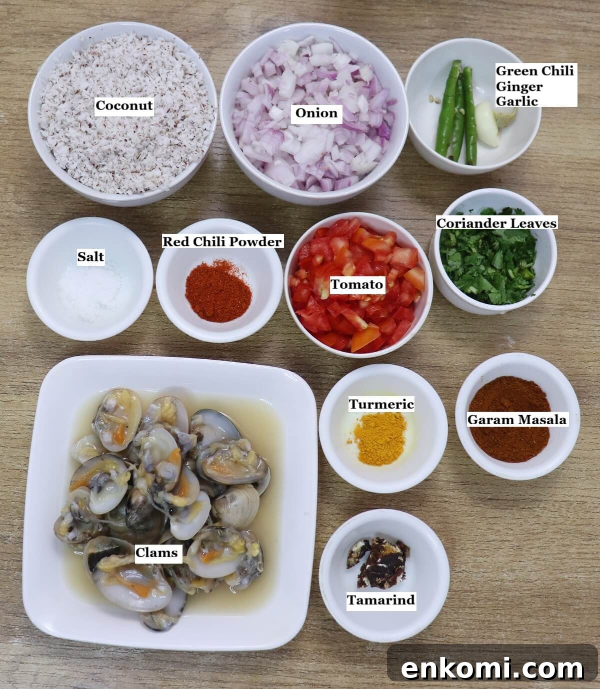 Authentic Goan Clam Curry Recipe 3 Individually labelled ingredients to make Goan clam curry are laid out on a table.