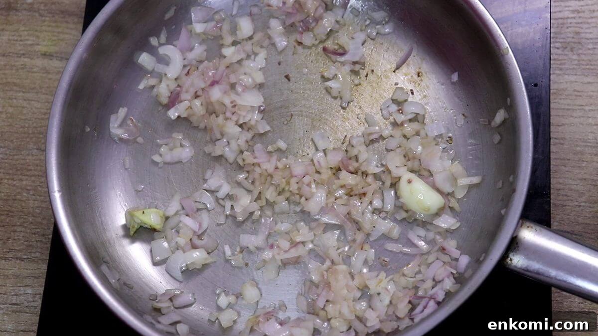 Authentic Goan Clam Curry Recipe 4 Sautéing chopped onion, ginger and garlic in oil.
