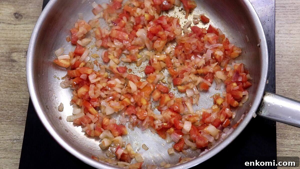Authentic Goan Clam Curry Recipe 8 Cooking chopped tomatoes until soft and mushy.