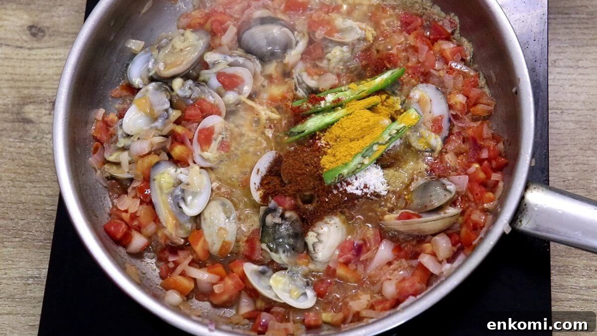 Authentic Goan Clam Curry Recipe 9 Adding clams and spices to the pan.
