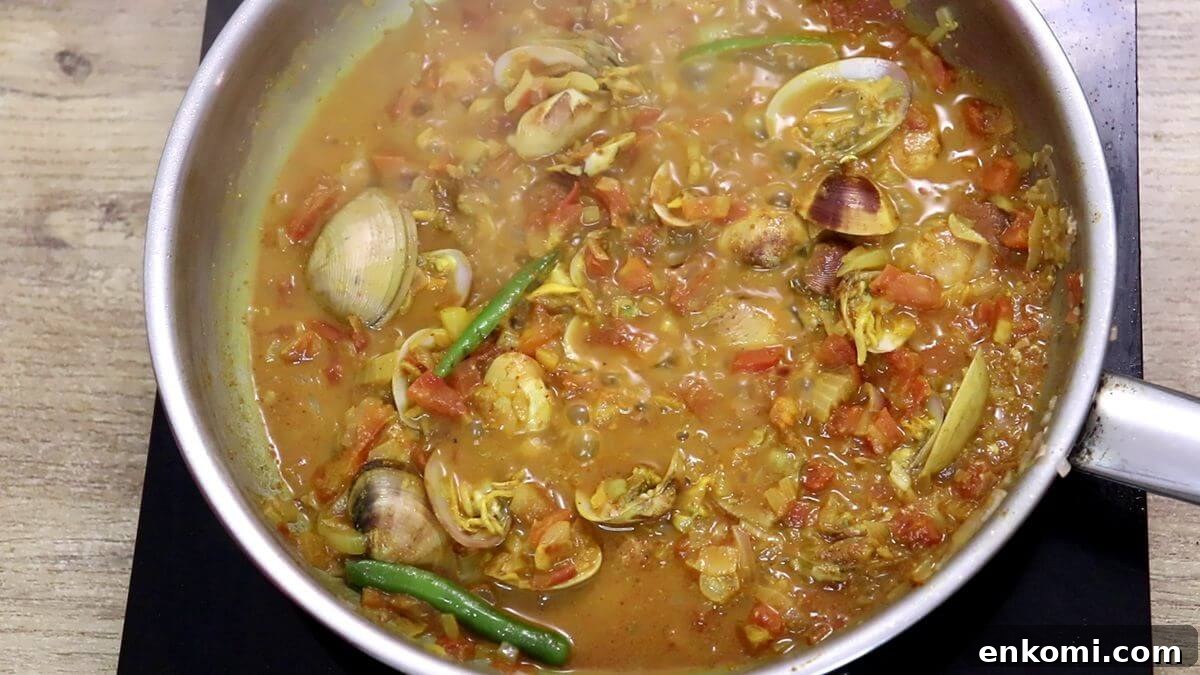 Authentic Goan Clam Curry Recipe 10 Cooking clams in the pan.