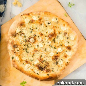 Garlic Lover's Pizza with Homemade Crust Recipe 11 A garlic pizza on a cutting board.