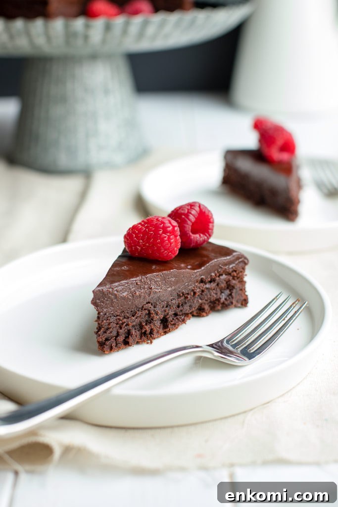 Decadent Flourless Chocolate Cake Recipe 2 A fudgy, rich chocolate cake that is naturally gluten-free. Make this by hand in one bowl, then top with the easiest chocolate ganache (just chocolate and cream!) and fresh fruit for an impressive party dessert!
