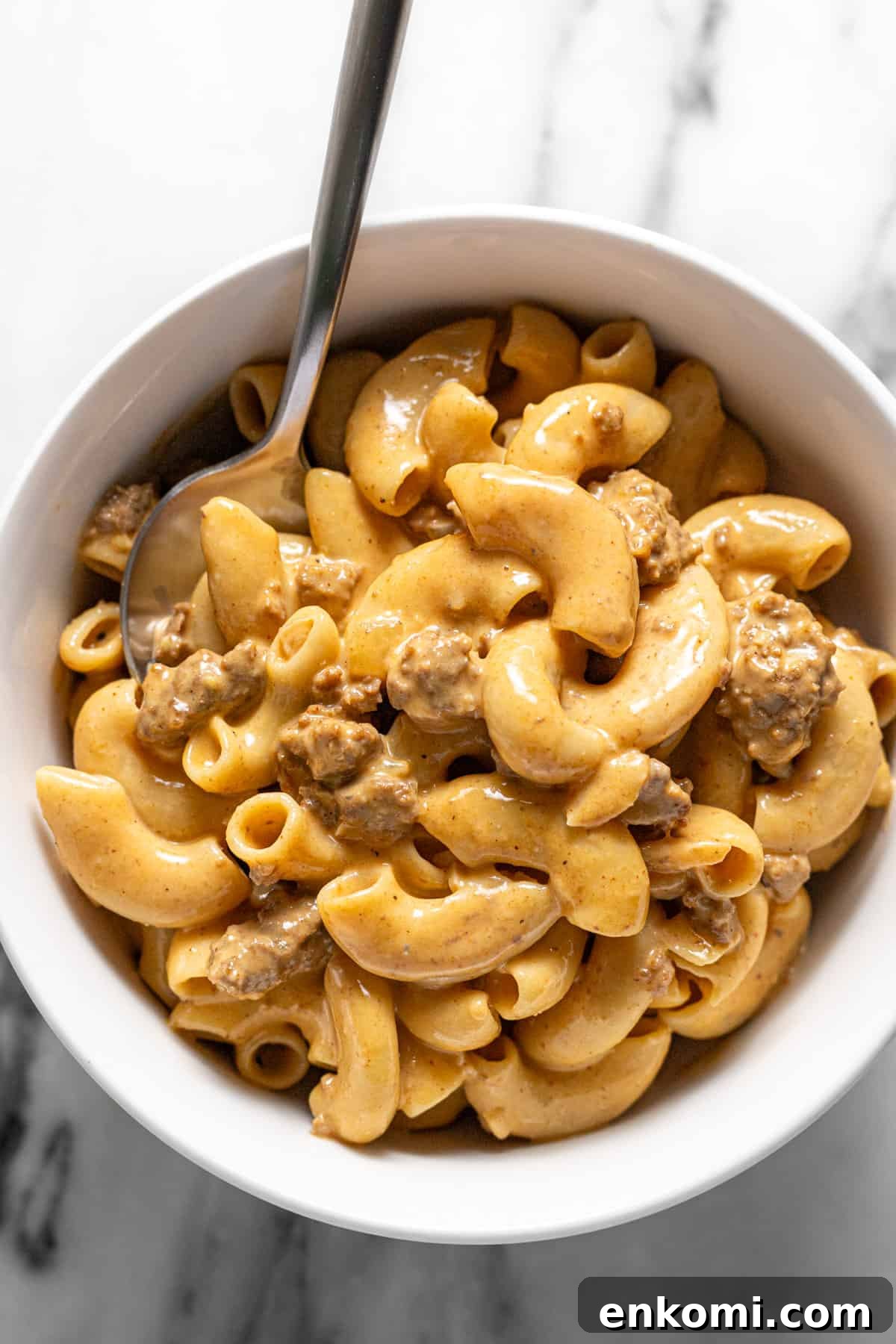Small bowl filled with homemade hamburger helper and a spoon.