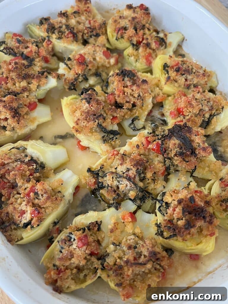 Oven-Roasted Italian Artichoke Hearts with Lemon Breadcrumbs 15 Finished, baked artichoke hearts in white baking dish.