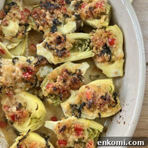 Oven-Roasted Italian Artichoke Hearts with Lemon Breadcrumbs 19 Finished, baked italian artichoke hearts oreganata in oval baking dish on yellow towel.