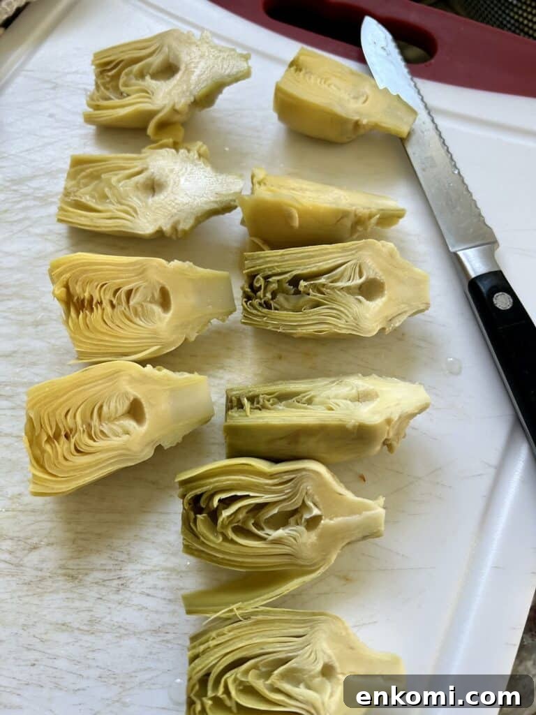 Oven-Roasted Italian Artichoke Hearts with Lemon Breadcrumbs 7 Cutting the artichoke hearts in half with serrated knife.