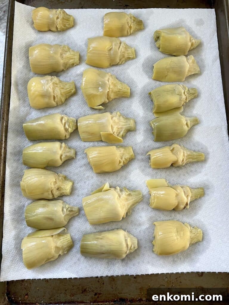 Oven-Roasted Italian Artichoke Hearts with Lemon Breadcrumbs 8 Artichoke hearts draining on paper towels.