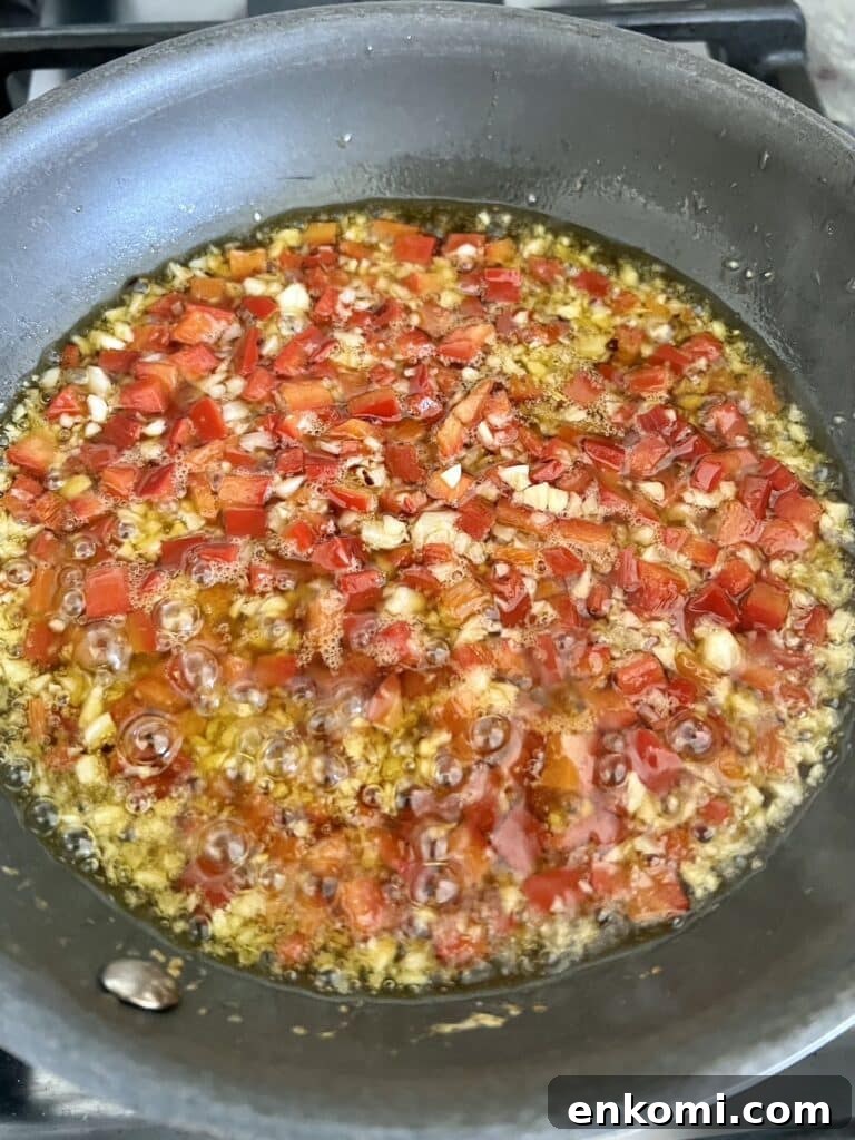 Oven-Roasted Italian Artichoke Hearts with Lemon Breadcrumbs 9 Sautéing chopped garlic, red bell peppers and crushed red pepper in olive oil in small skillet.