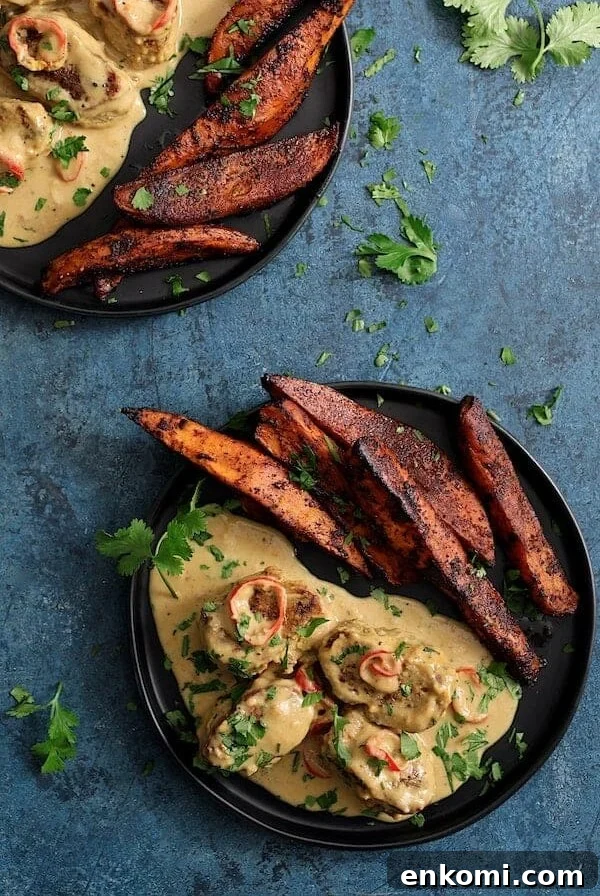 Spicy Tahini Pork Medallions with Harissa Sweet Potato Wedges 13 Two servings of Spicy Tahini Pork Medallions with Harissa Roasted Sweet Potato Wedges on black plates.