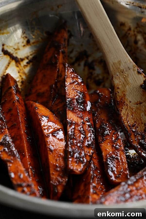 Spicy Tahini Pork Medallions with Harissa Sweet Potato Wedges 3 Photo of sweet potato wedges tossed with harissa paste before being roasted.