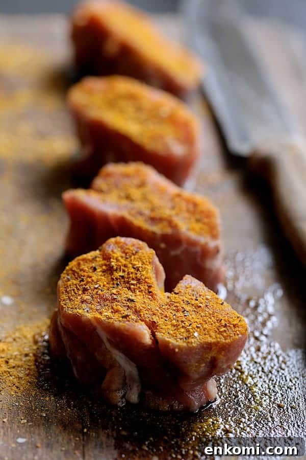 Spicy Tahini Pork Medallions with Harissa Sweet Potato Wedges 6 Photo of four uncooked pork medallions on wood cutting board sprinkled with spice rub.