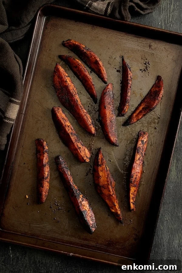 Spicy Tahini Pork Medallions with Harissa Sweet Potato Wedges 10 Photo of Harissa Roasted Sweet Potato Wedges on baking sheet.
