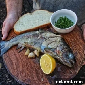 Trout in a Cast-Iron Skillet with Lemon and Herbs 4 cast iron trout ready to eat
