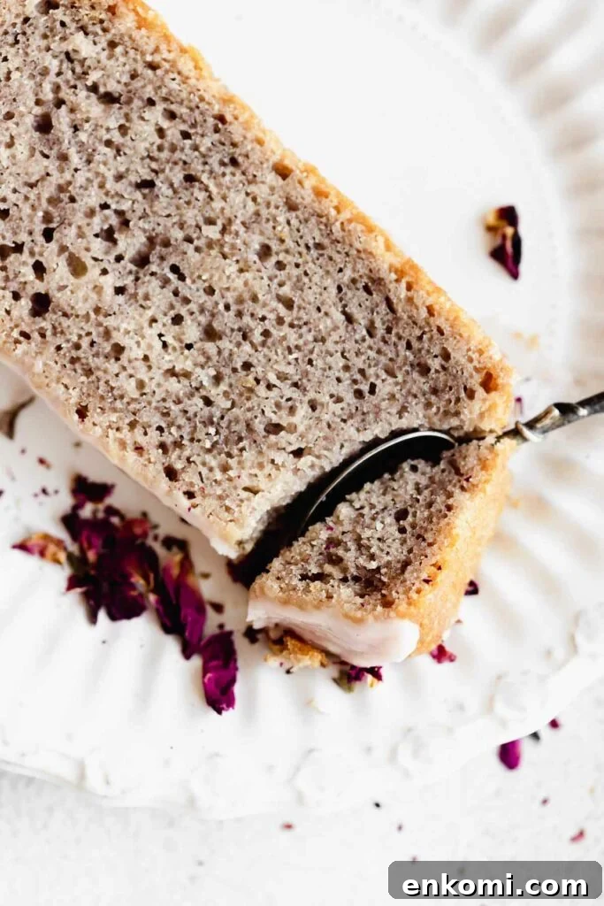 Vegan Rose Loaf Cake with Silky Petal Glaze 2 taking a bite of a slice of rose cake