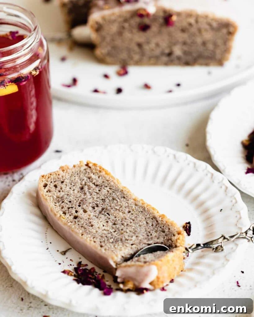 Vegan Rose Loaf Cake with Silky Petal Glaze 5 rose cake on a plate with a spoon