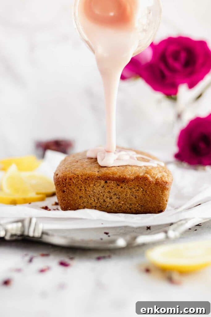Vegan Rose Loaf Cake with Silky Petal Glaze 10 pouring the rose glaze over the baked loaf cake
