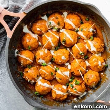 Buffalo Chicken Meatballs: Whole30 and Keto Recipe 2 buffalo chicken meatballs in a pan with green onions