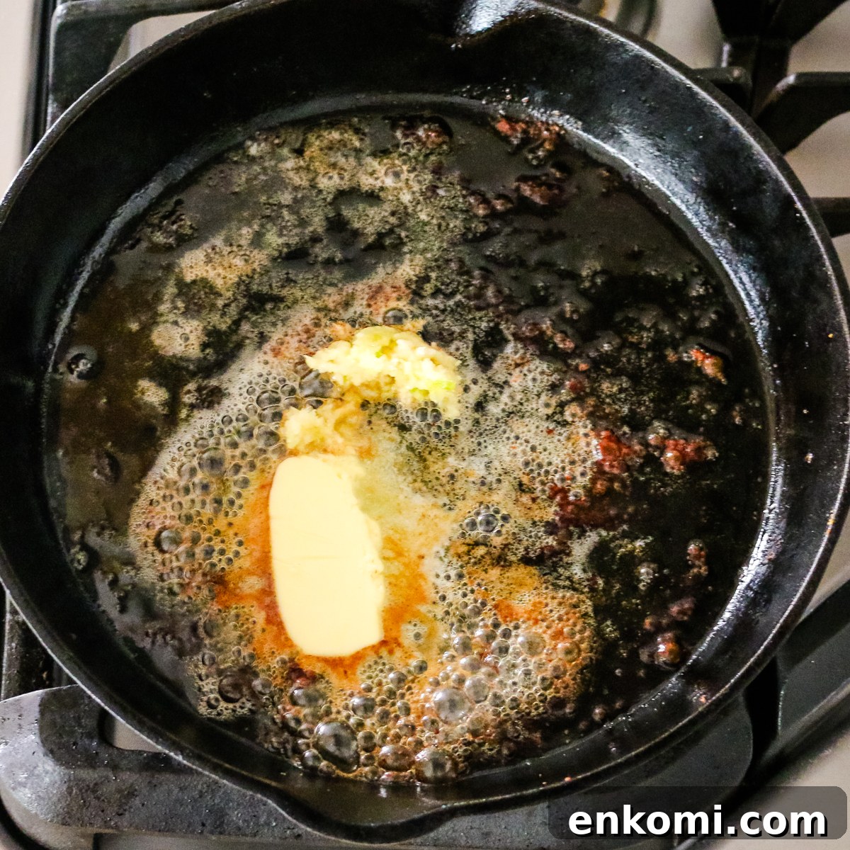 butter melting in cast iron skillet.