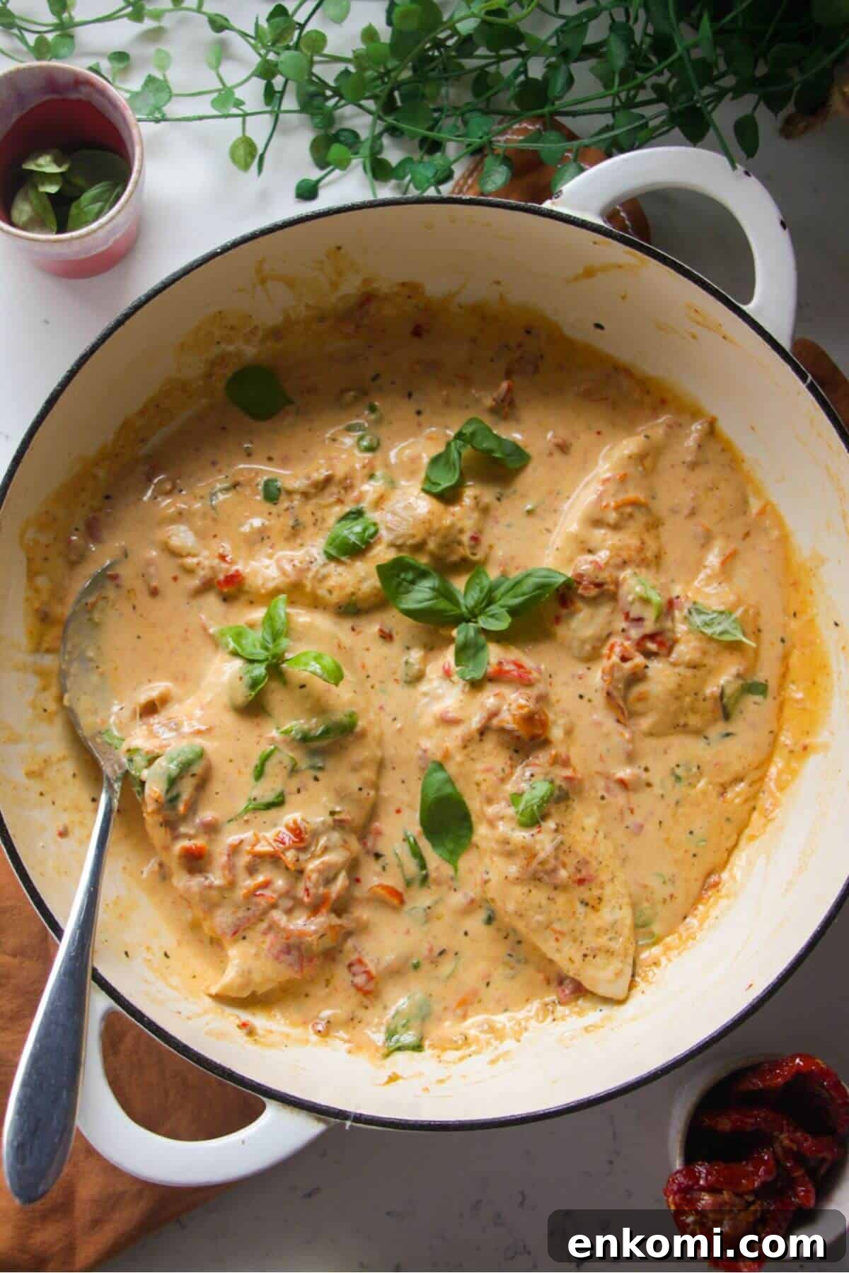 20-Minute Marry Me Chicken with Creamy Sun-Dried Tomato Sauce 2 Chicken breasts in creamy sundried tomato sauce in a large white skillet.