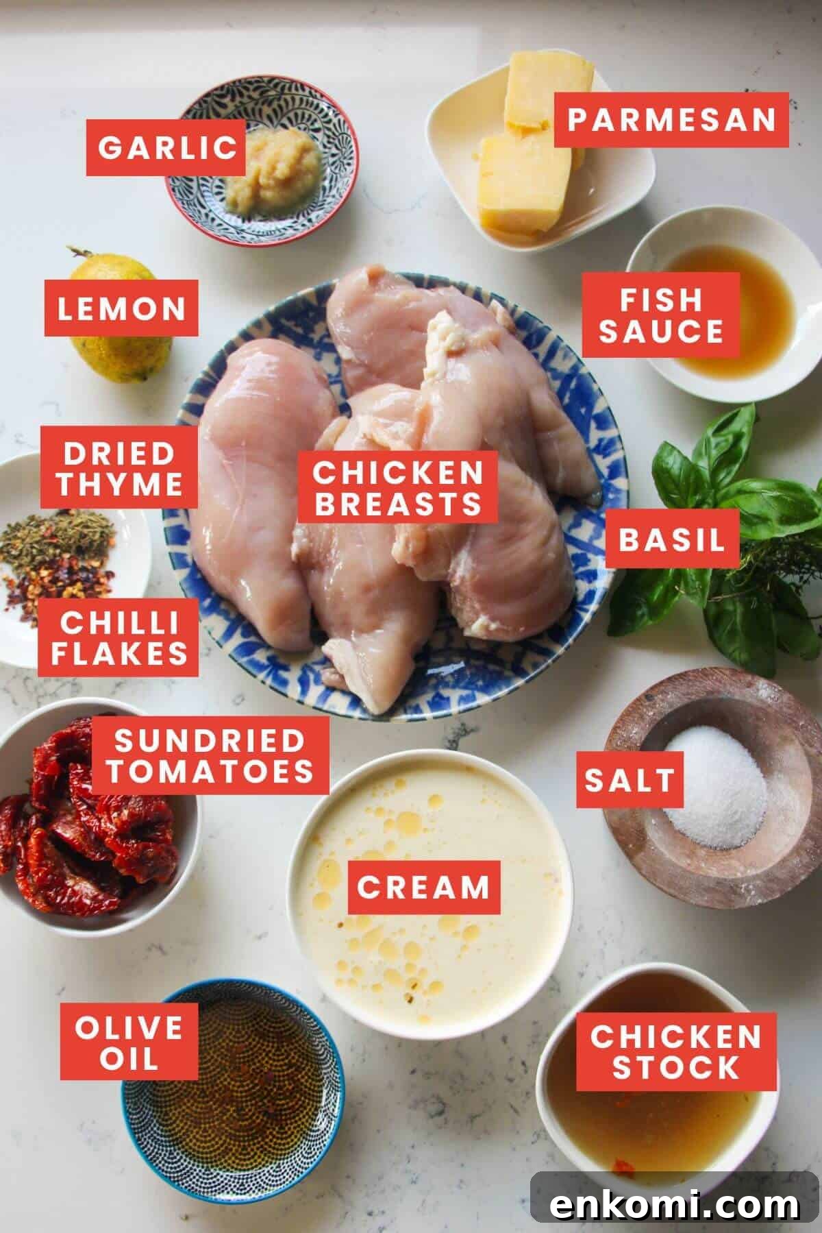 20-Minute Marry Me Chicken with Creamy Sun-Dried Tomato Sauce 3 Ingredients for marry me chicken laid out on a white marble background and labelled.