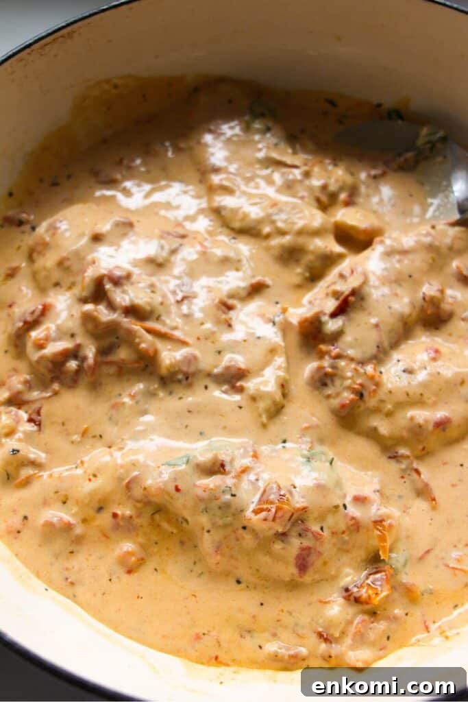 20-Minute Marry Me Chicken with Creamy Sun-Dried Tomato Sauce 9 Cooked chicken breasts added back into creamy sundried tomato sauce in a large white skillet.
