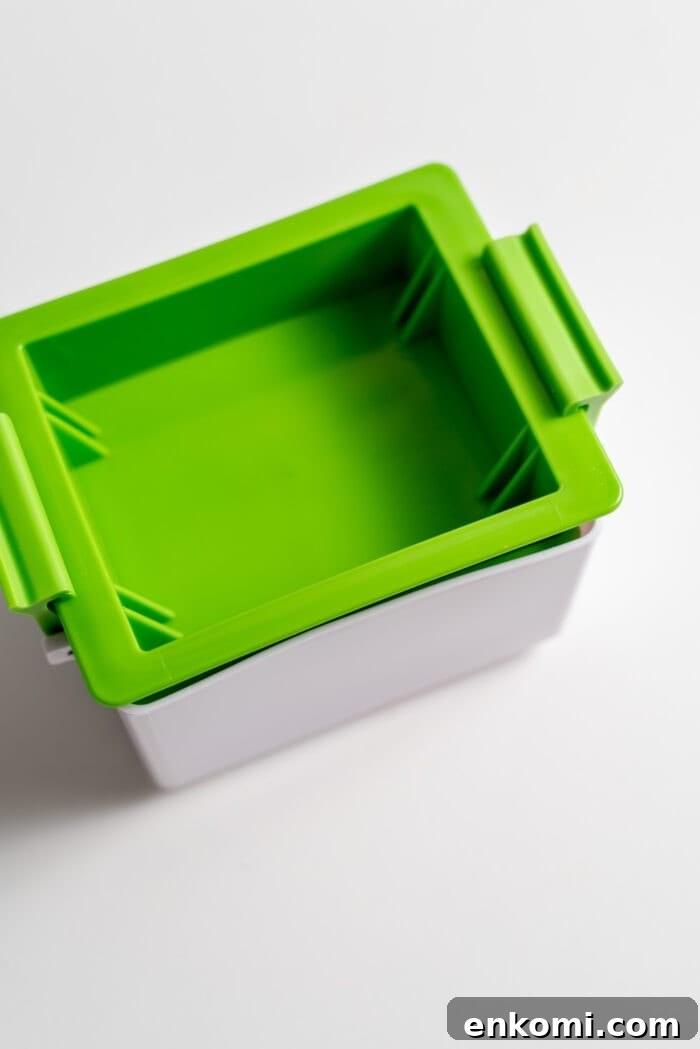 How to Press Tofu for Crispy, Firm Results 9 A sealed green tofu press.