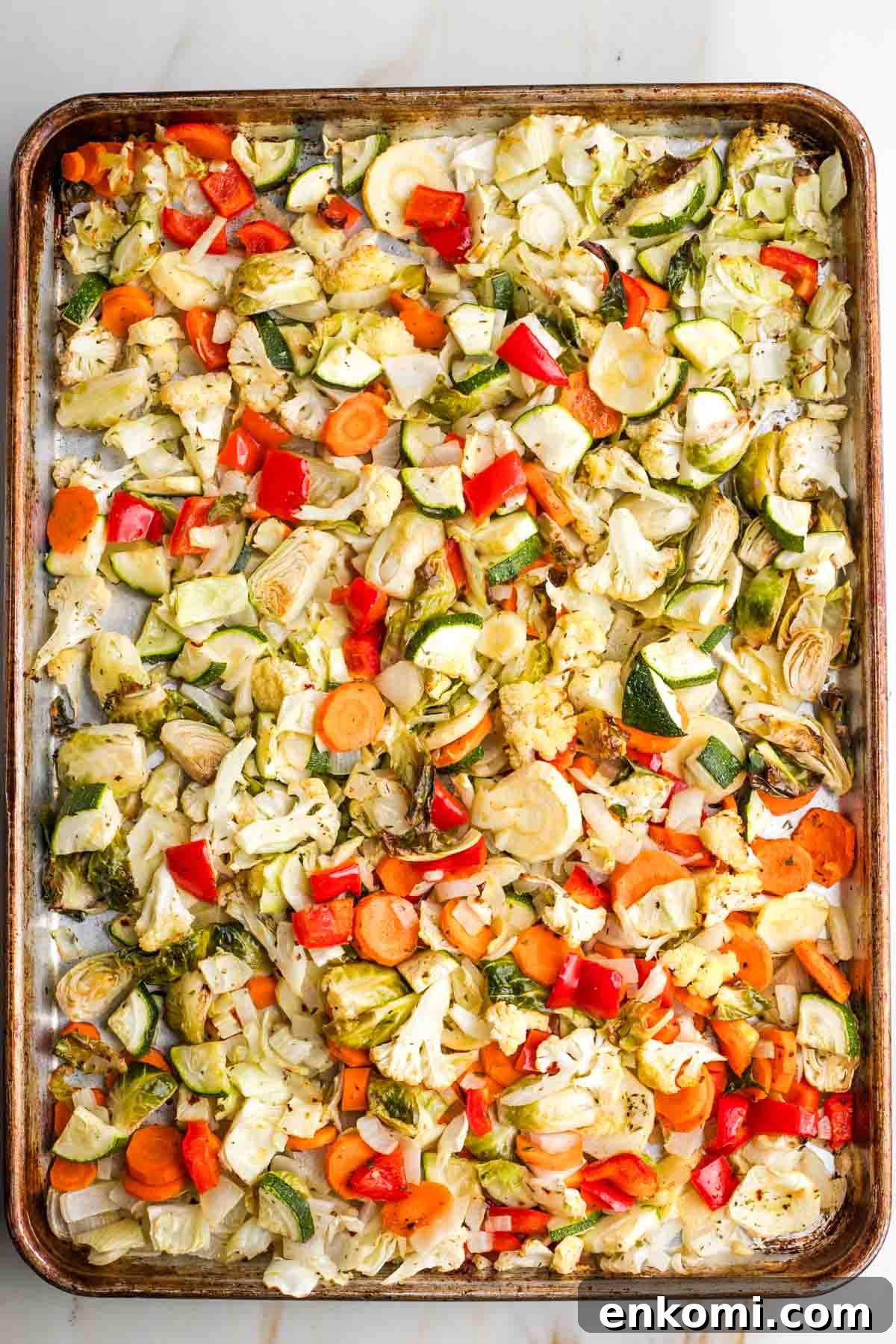 Sheet pan full of colorful roasted vegetables.