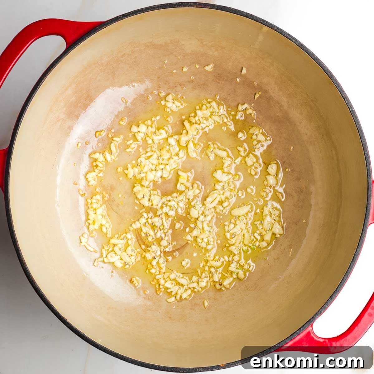 Garlic being sautéed in a pot.