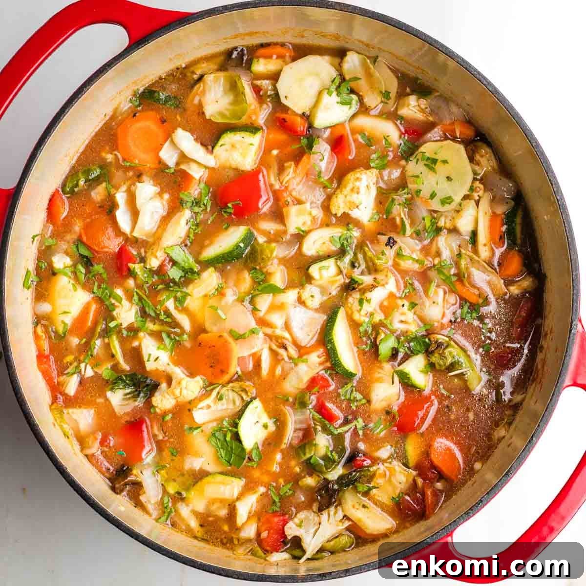 Dutch oven filled with chunky roasted vegetable soup.