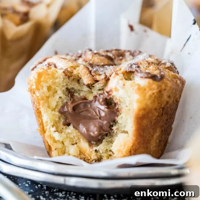30 Muffin Recipes: Sweet, Savory & Seasonal Ideas 19 Nutella muffin bitten to show a nutella filling.