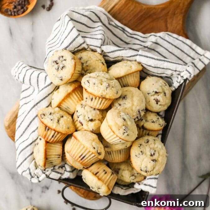 30 Muffin Recipes: Sweet, Savory & Seasonal Ideas 20 Overhead view of mini muffins in a baking pan lined with a striped tea towel.