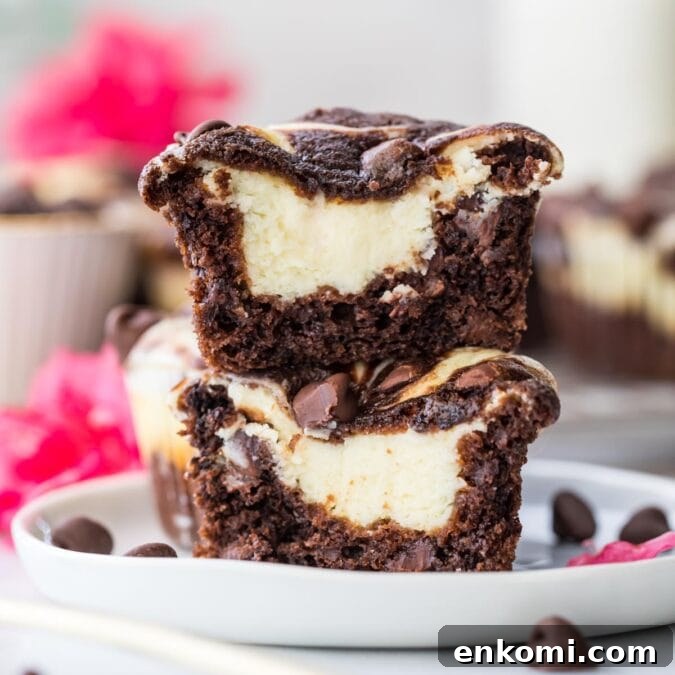 30 Muffin Recipes: Sweet, Savory & Seasonal Ideas 21 a chocolate cheesecake muffin cut in half and stacked on top of itself to show creamy cheesecake center.